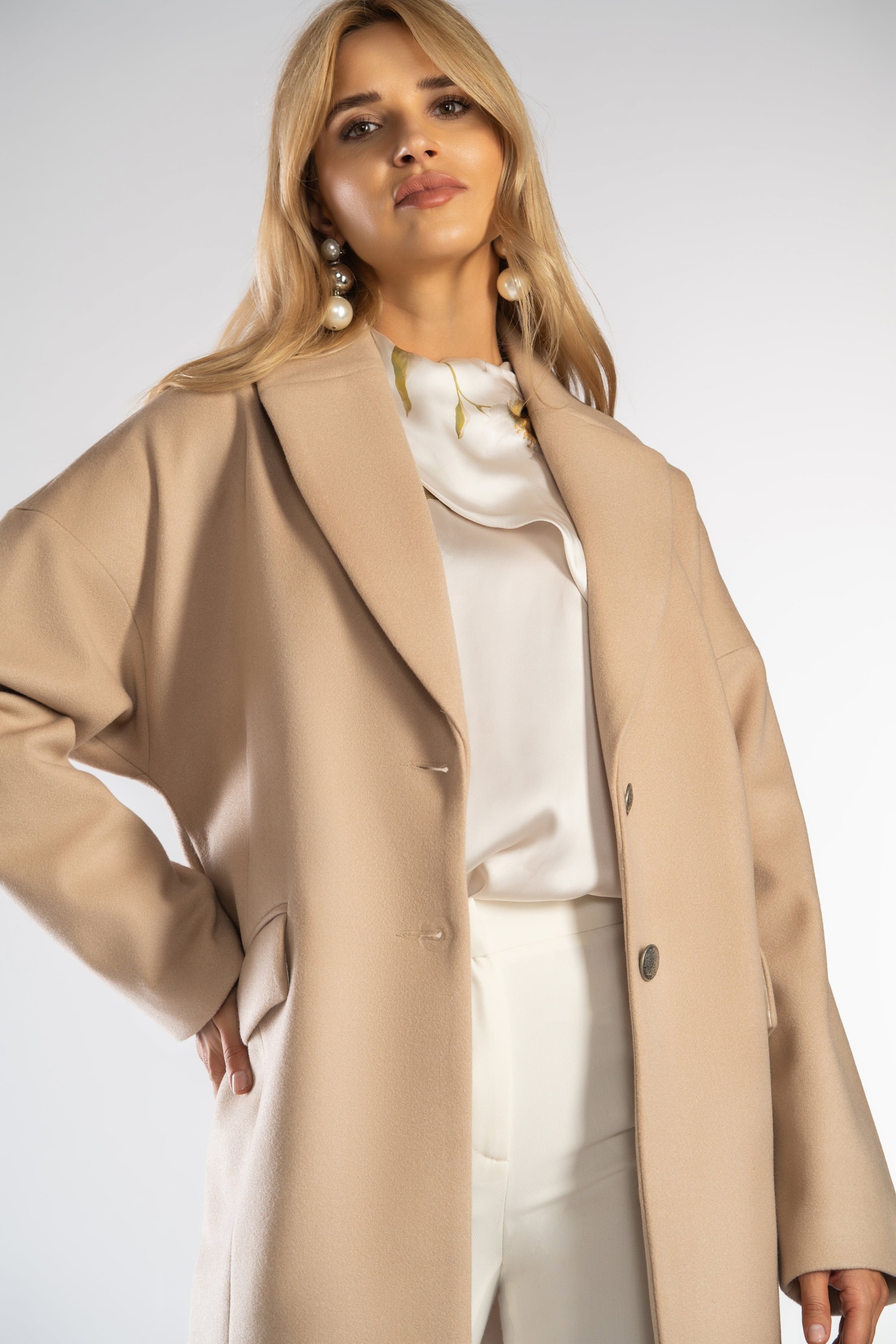 Płaszcz typu oversize z opuszczonym rękawem.